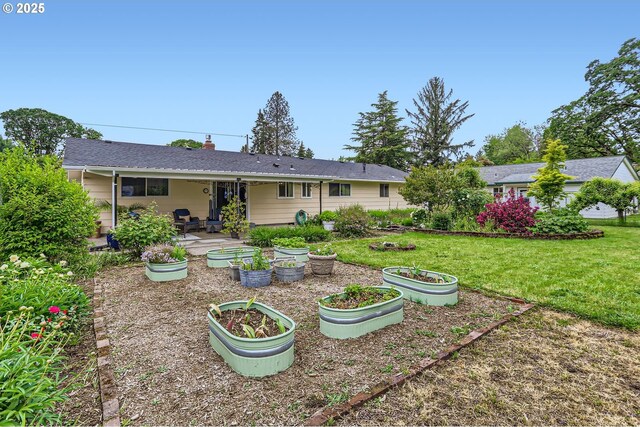 157 NE 11th Dr, Hillsboro, OR 97124 - back of house with a lawn, a patio area, and a vegetable garden