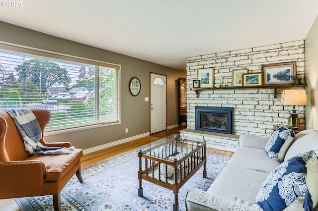157 NE 11th Dr, Hillsboro, OR 97124 - living room with baseboards, a fireplace, and wood finished floors