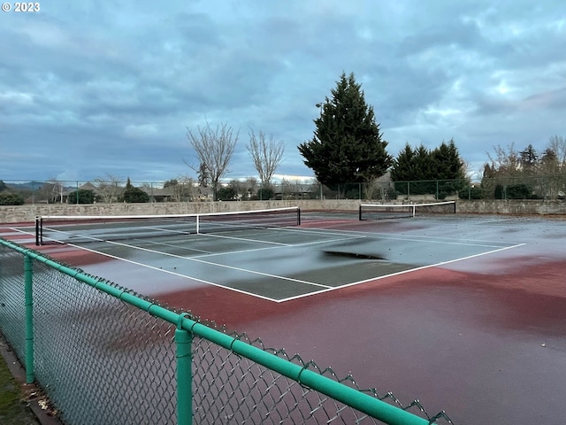 view of sport court with fence