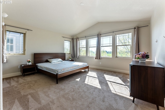 bedroom featuring vaulted ceiling, baseboards, and light colored carpet