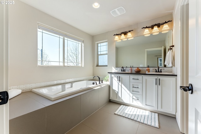 bathroom featuring a sink, double vanity, visible vents, recessed lighting, and a garden tub