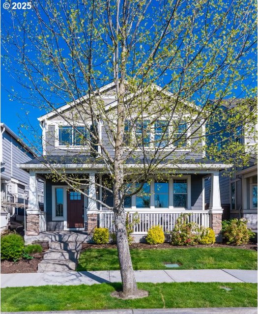view of front of home featuring a porch and stone siding