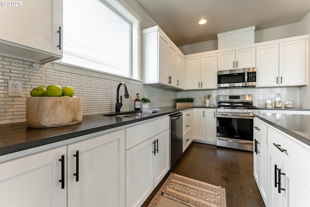 kitchen featuring a sink, white cabinetry, appliances with stainless steel finishes, and tasteful backsplash