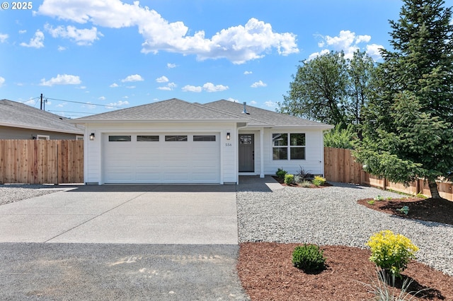 ranch-style home featuring driveway, roof with shingles, an attached garage, and fence