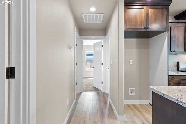 hall featuring baseboards, light wood-type flooring, visible vents, and recessed lighting