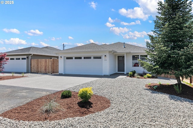 ranch-style house with roof with shingles, driveway, fence, and a garage