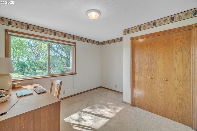 unfurnished office with baseboards and light carpet
