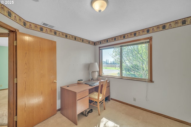 carpeted office with visible vents and baseboards