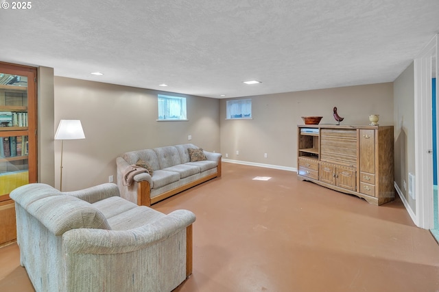 living area with recessed lighting, a textured ceiling, and baseboards