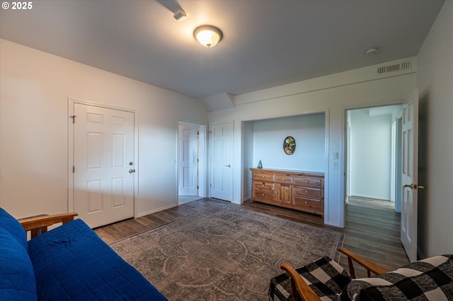 bedroom with dark hardwood / wood-style flooring