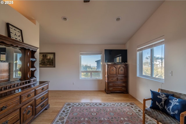 sitting room with lofted ceiling and light hardwood / wood-style flooring