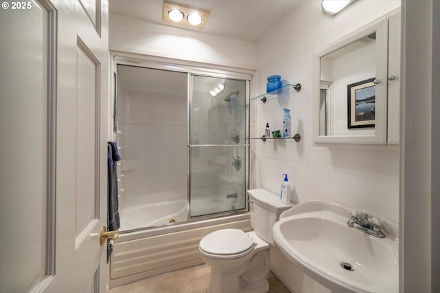 full bathroom featuring enclosed tub / shower combo, toilet, and sink