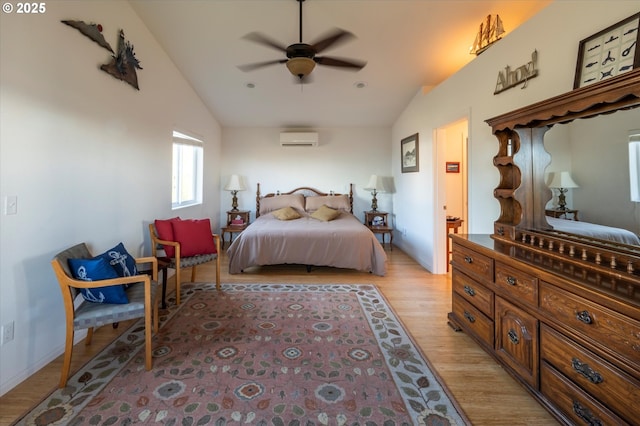 bedroom featuring lofted ceiling, a wall mounted air conditioner, ceiling fan, and light hardwood / wood-style floors