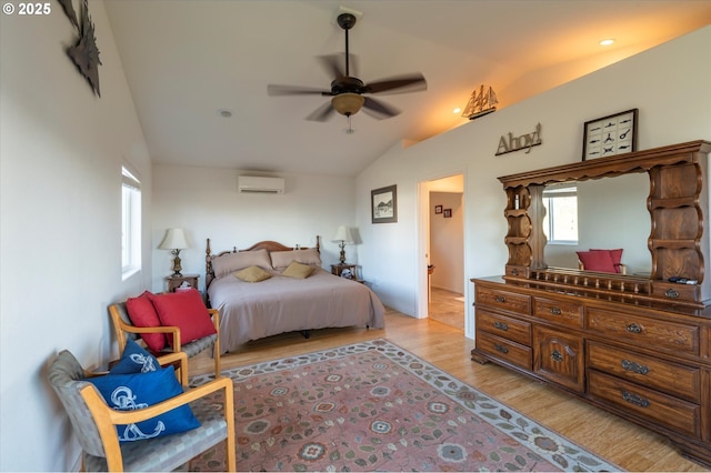 bedroom featuring ceiling fan, light hardwood / wood-style floors, vaulted ceiling, and a wall unit AC