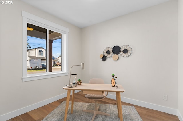 office space with wood finished floors and baseboards