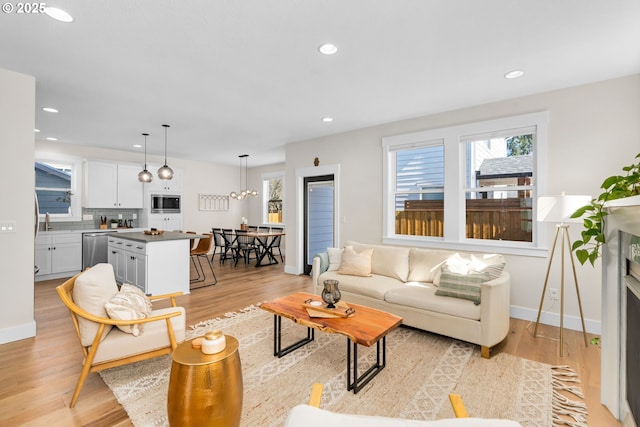 living room with recessed lighting and light wood-style flooring