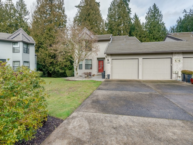 view of front facade with a garage, a front yard, brick siding, and driveway