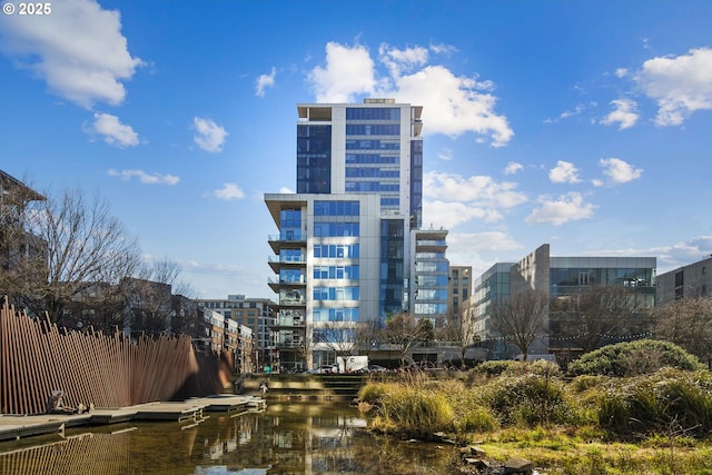 view of property featuring a water view and a city view