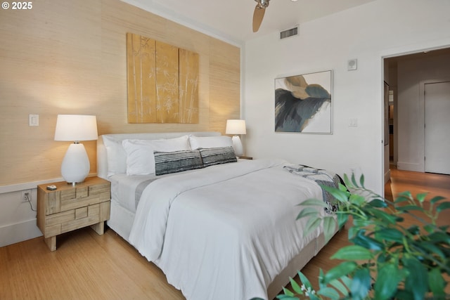 bedroom with wood finished floors and visible vents