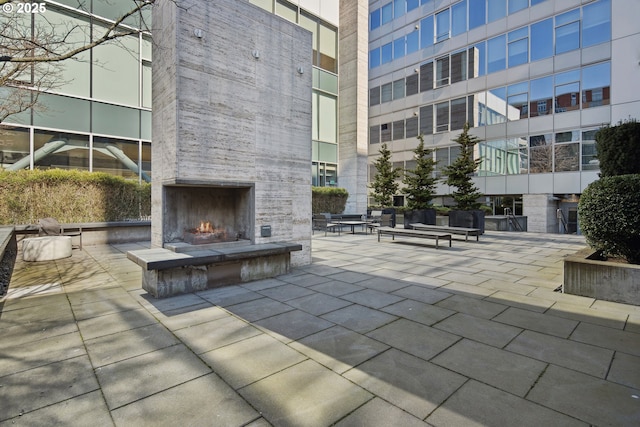 view of patio featuring an outdoor stone fireplace