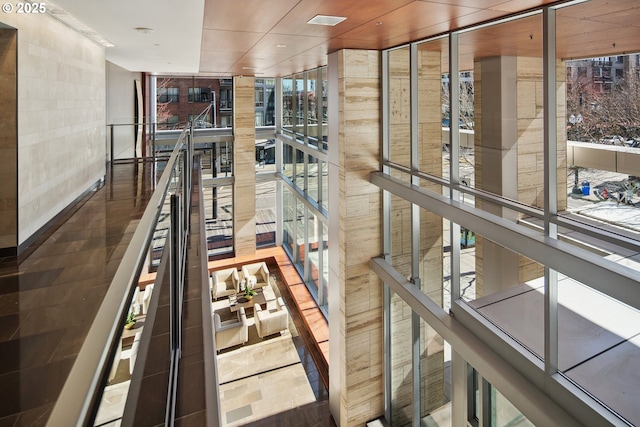 staircase featuring a wall of windows