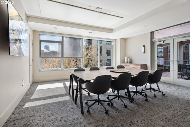 dining space featuring plenty of natural light, french doors, and carpet floors