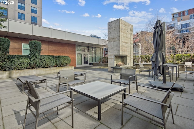 view of patio / terrace with an outdoor living space with a fireplace