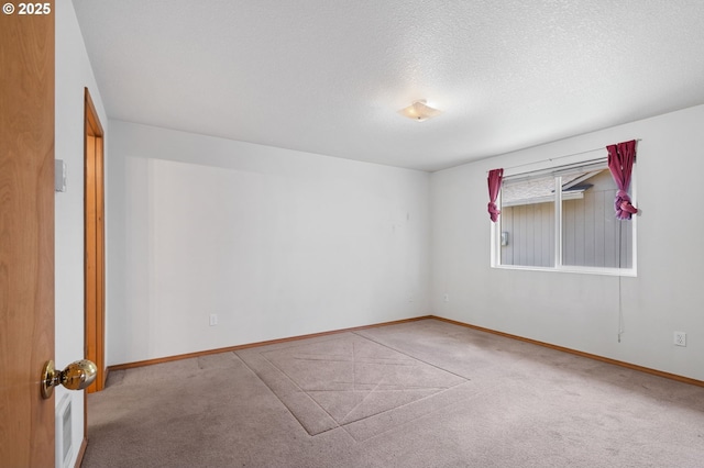 carpeted empty room featuring visible vents, a textured ceiling, and baseboards