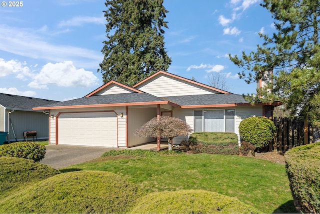 ranch-style home featuring a garage, a shingled roof, concrete driveway, fence, and a front yard