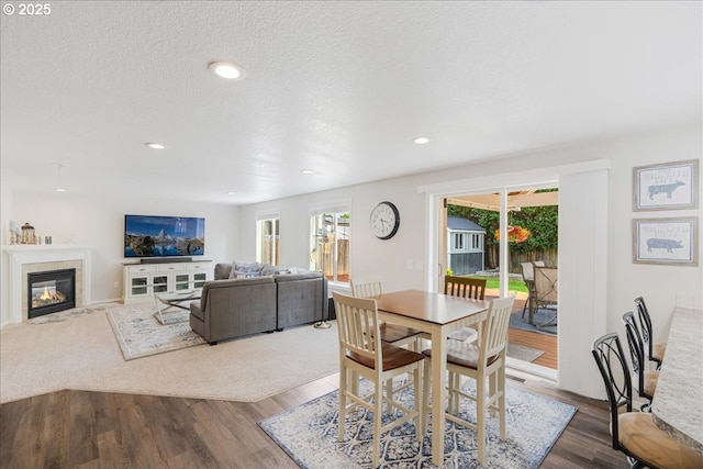 1133 7th St, Lafayette, OR 97127 - dining area with healthy amount of natural light, wood finished floors, a tiled fireplace, recessed lighting, and a textured ceiling