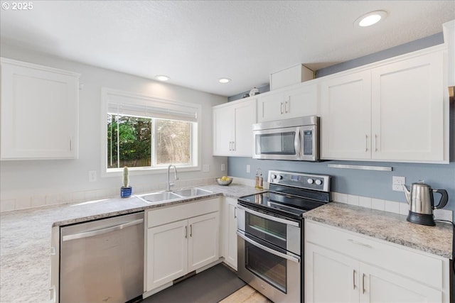 1133 7th St, Lafayette, OR 97127 - kitchen featuring appliances with stainless steel finishes, white cabinetry, and recessed lighting