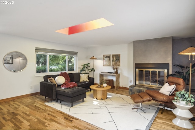 7335 SE 48th Ave, Portland, OR 97206 - living area featuring a skylight, wood finished floors, baseboards, and a glass covered fireplace