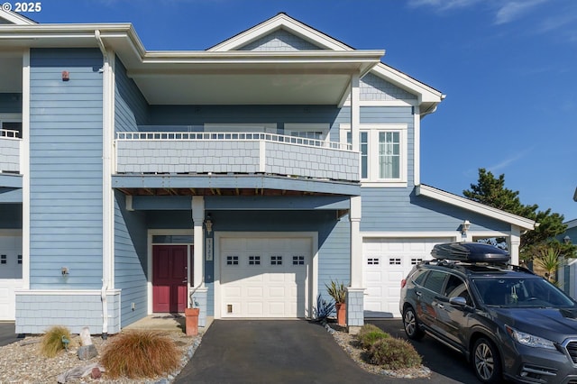 1327 Village Loop, Bandon, OR 97411 - view of front facade with aphalt driveway, a garage, and a balcony