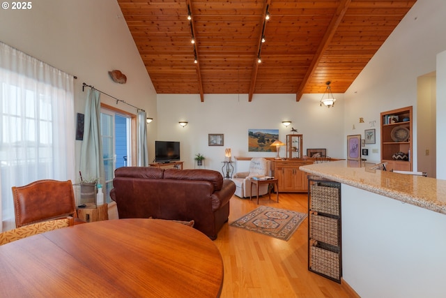 1327 Village Loop, Bandon, OR 97411 - living room featuring beam ceiling, high vaulted ceiling, light wood-type flooring, and wooden ceiling