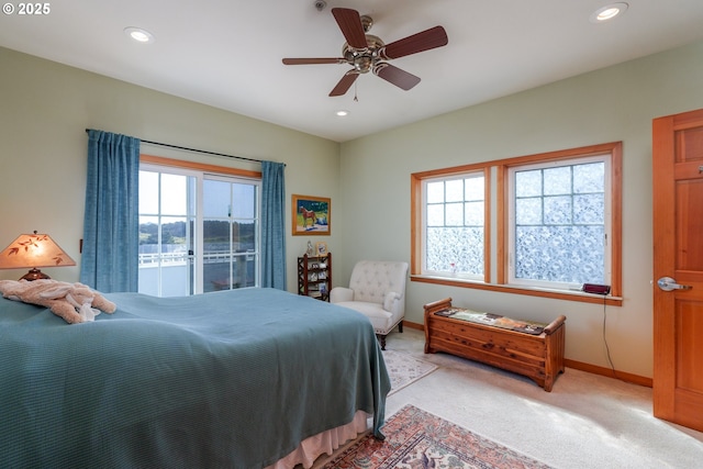 1327 Village Loop, Bandon, OR 97411 - bedroom featuring light carpet, baseboards, multiple windows, and recessed lighting