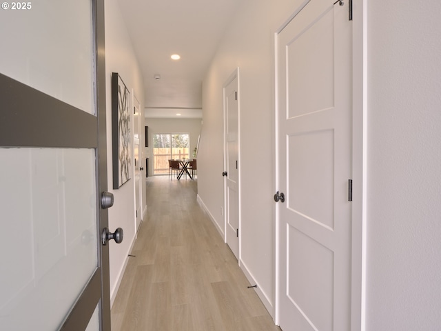 corridor featuring recessed lighting, light wood-style floors, and baseboards