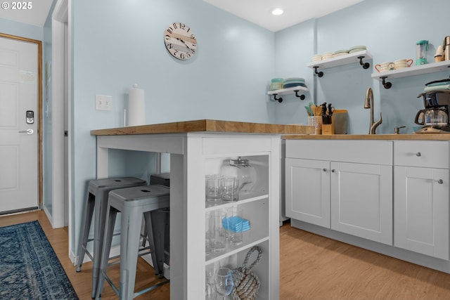 2316 Beach Dr Unit 157, Seaside, OR 97138 - kitchen with open shelves, white cabinets, light wood finished floors, recessed lighting, and a sink