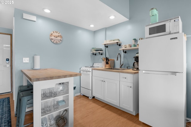 2316 Beach Dr Unit 157, Seaside, OR 97138 - kitchen with white appliances, a sink, wooden counters, open shelves, and recessed lighting
