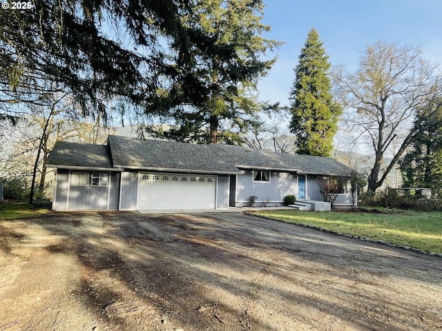 ranch-style house featuring driveway and an attached garage