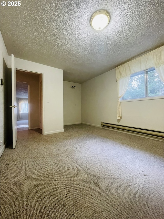 empty room with a healthy amount of sunlight, baseboards, carpet floors, and a baseboard radiator