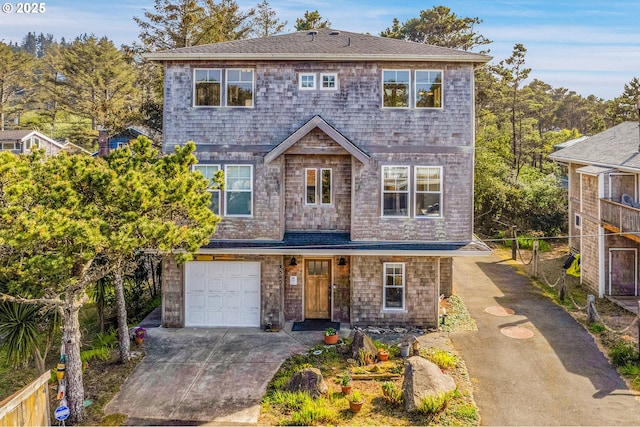 view of front of house with fence, driveway, and a garage