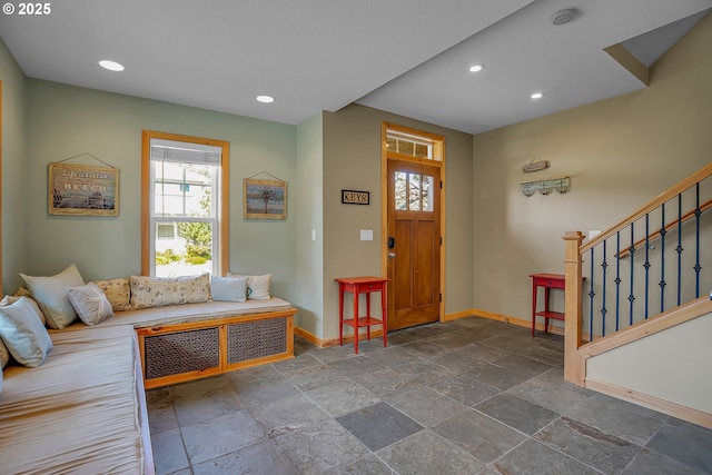 entrance foyer featuring baseboards, recessed lighting, and stone tile floors