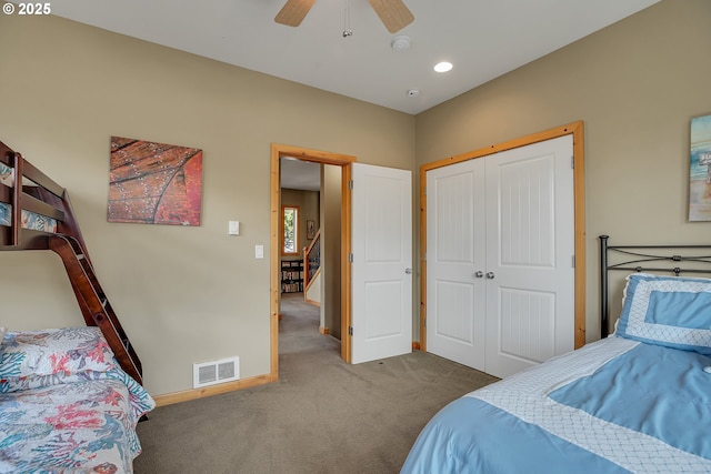 carpeted bedroom featuring baseboards, ceiling fan, a closet, and visible vents