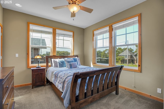 bedroom featuring baseboards, ceiling fan, and carpet flooring