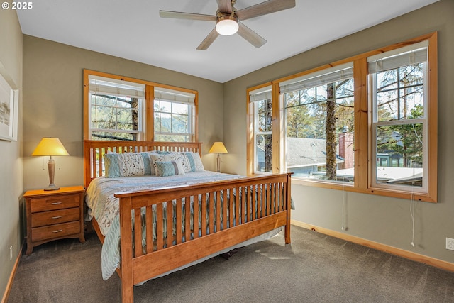carpeted bedroom featuring baseboards and ceiling fan