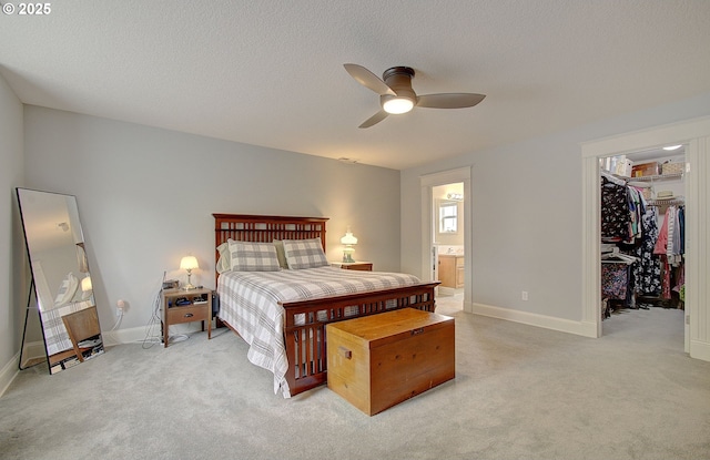 688 53rd St, Washougal, WA 98671 - bedroom featuring a walk in closet, light colored carpet, ensuite bath, a textured ceiling, and baseboards