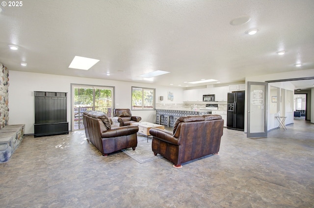 688 53rd St, Washougal, WA 98671 - living area featuring a skylight, a textured ceiling, and recessed lighting