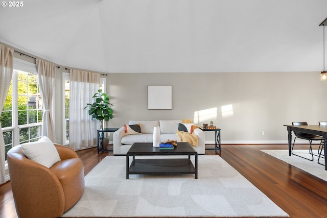 15421 SW Thurston Ln, Portland, OR 97224 - living room featuring dark wood-type flooring, lofted ceiling, and baseboards