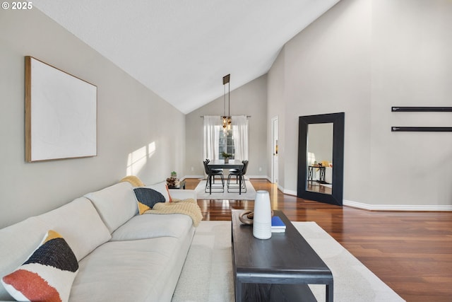 15421 SW Thurston Ln, Portland, OR 97224 - living area with wood finished floors, high vaulted ceiling, and baseboards
