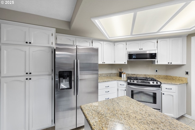 15421 SW Thurston Ln, Portland, OR 97224 - kitchen featuring stainless steel appliances, white cabinets, and light stone countertops